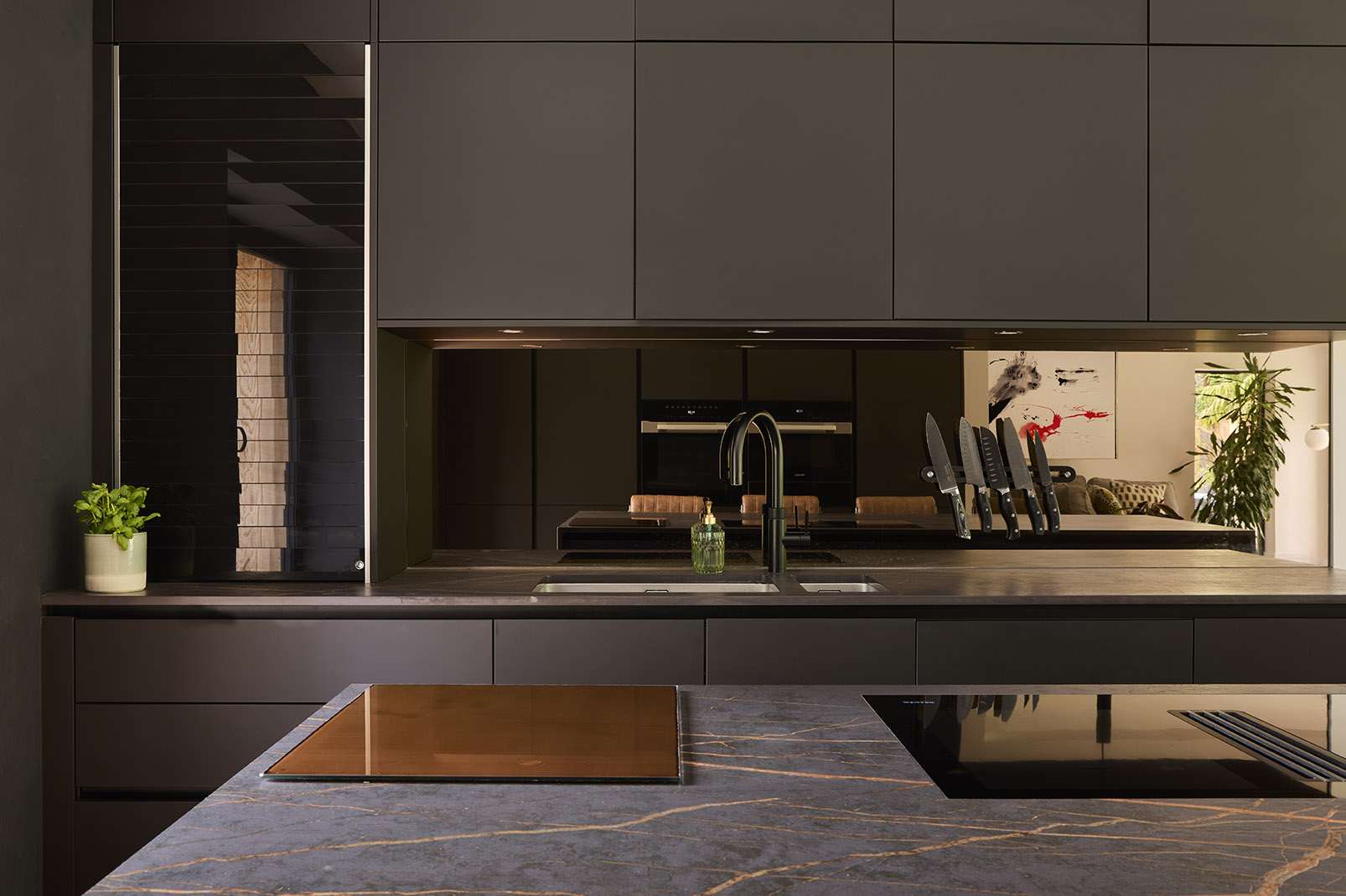 Dark wood modern kitchen design in new build home.