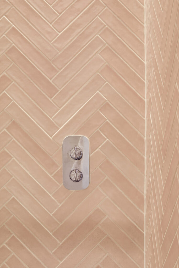 En suite bathroom with pink Minoli tiles.